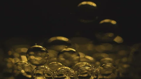Beautiful colored bubbles in a liquid on a black background. Close-up. Slow Stock Footage 97849888