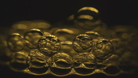Beautiful colored bubbles in a liquid on a black background. Close-up. Slow 스톡 동영상 97849929