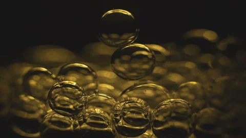 Beautiful colored bubbles in a liquid on a black background. Close-up. Slow Video stock 97849945