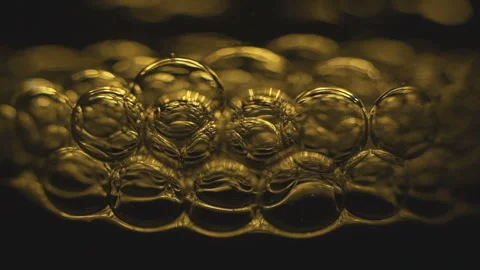 Beautiful colored bubbles in a liquid on a black background. Close-up. Slow Stock-Footage 97849970