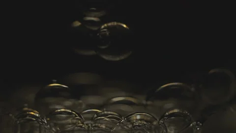 Beautiful colored bubbles in a liquid on a black background. Close-up. Slow Video stock 97850001