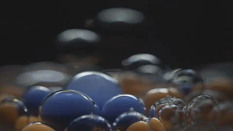 Beautiful colored bubbles in a liquid on a black background. Close-up. Slow Video stock 97852316