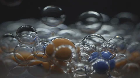 Beautiful colored bubbles in a liquid on a black background. Close-up. Slow Stock Footage 97852427
