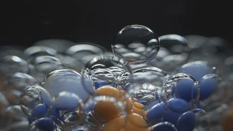 Beautiful colored bubbles in a liquid on a black background. Close-up. Slow Stock Footage 97852521