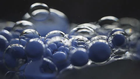 Beautiful colored bubbles in a liquid on a black background. Close-up. Slow Stock Footage 97852620