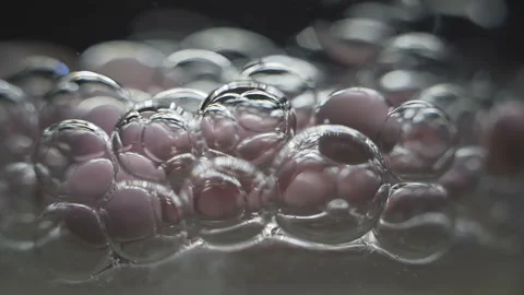 Beautiful colored bubbles in a liquid on a black background. Close-up. Slow Stock-Footage 97852860