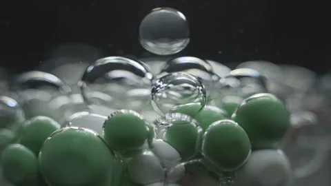 Beautiful colored bubbles in a liquid on a black background. Close-up. Slow Stock Footage 97852882