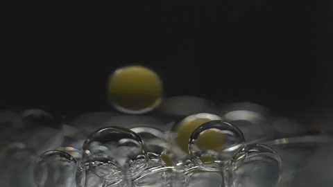 Beautiful colored bubbles in a liquid on a black background. Close-up. Slow Video stock 97852926