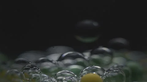 Beautiful colored bubbles in a liquid on a black background. Close-up. Slow Stock Footage 97852959