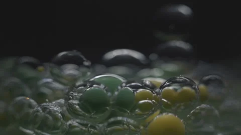 Beautiful colored bubbles in a liquid on a black background. Close-up. Slow Video stock 97852984