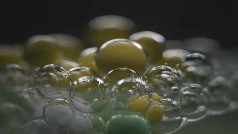 Beautiful colored bubbles in a liquid on a black background. Close-up. Slow 스톡 동영상 97853043