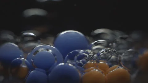 Beautiful colored bubbles in a liquid on a black background. Close-up. Slow Stock Footage 97853137