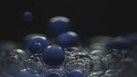 Beautiful colored bubbles in a liquid on a black background. Close-up. Slow Stock Footage 97853140
