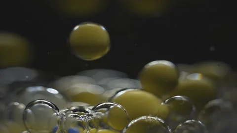Beautiful colored bubbles in a liquid on a black background. Close-up. Slow Video stock 97853285