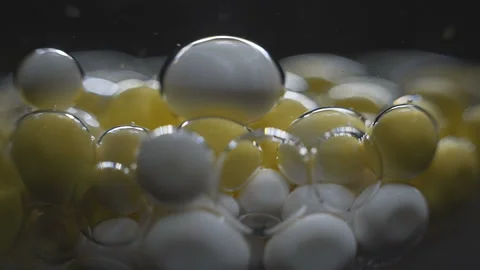 Beautiful colored bubbles in a liquid on a black background. Close-up. Slow 動画素材 97853426