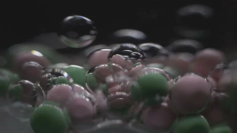 Beautiful colored bubbles in a liquid on a black background. Close-up. Slow Video stock 97853494