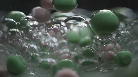 Beautiful colored bubbles in a liquid on a black background. Close-up. Slow Video stock 97853639