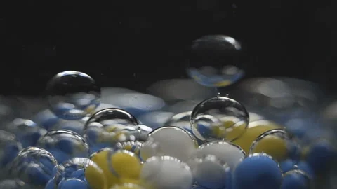 Beautiful colored bubbles in a liquid on a black background. Close-up. Slow Video stock 97853796