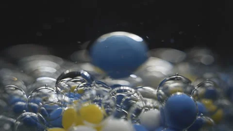 Beautiful colored bubbles in a liquid on a black background. Close-up. Slow Stock Footage 97853828
