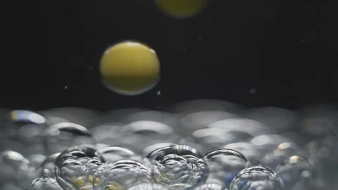 Beautiful colored bubbles in a liquid on a black background. Close-up. Slow Video stock 97853855