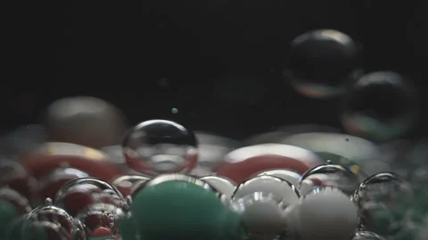 Beautiful colored bubbles in a liquid on a black background. Close-up. Slow Stock Footage 97853979