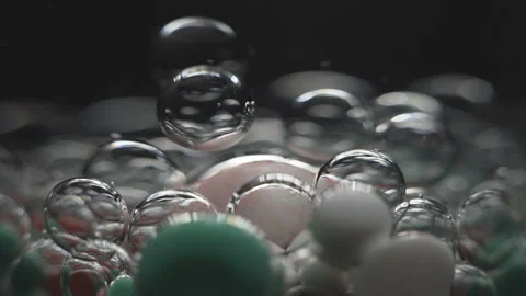 Beautiful colored bubbles in a liquid on a black background. Close-up. Slow 스톡 동영상 97854009