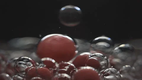 Beautiful colored bubbles in a liquid on a black background. Close-up. Slow Video stock 97854014