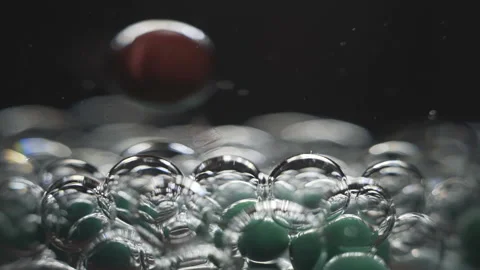 Beautiful colored bubbles in a liquid on a black background. Close-up. Slow Stock Footage 97854060