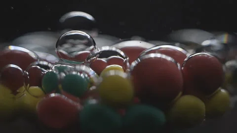 Beautiful colored bubbles in a liquid on a black background. Close-up. Slow Video stock 97854081