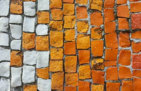 Beautiful colorful background of old mosaic, colorful little pebbles orange a Stock Photos
