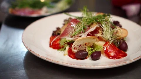 Beautiful colorful delicious Caesar salad mix with prosciutto and fresh Stock Footage 106978294