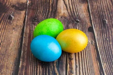 Beautiful colorful Easter eggs. Easter concept on dark wooden background, clo Stock Photos