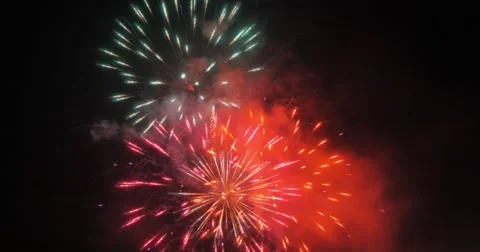Beautiful colorful fireworks display over black sky background. 4K. Stock Footage