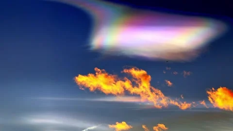 Beautiful Colorful Rainbow Clouds (Cloud Iridescence) and an Airplane Stockbeeldmateriaal 269378505