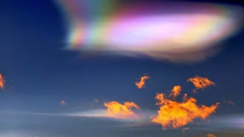 Beautiful Colorful Rainbow Clouds (Cloud Iridescence) and an Airplane Stock Footage 276899281