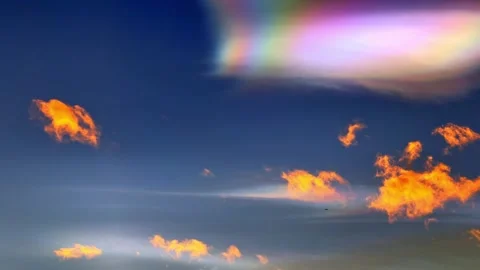 Beautiful Colorful Rainbow Clouds (Cloud Iridescence) and an Airplane Stockbeeldmateriaal 276899285