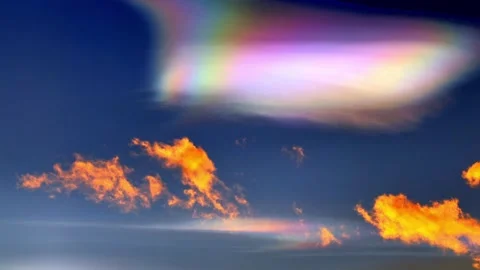 Beautiful Colorful Rainbow Clouds (Cloud Iridescence) Against Blue Sky in Sunset Stock Footage 337855405