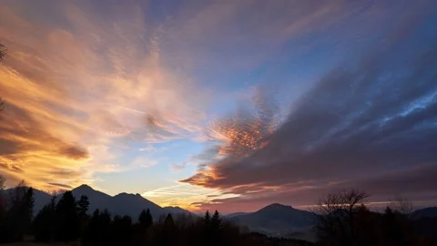 A beautiful colorful sunset, clouds changing colors from yellow to red. Stock Footage 164852792