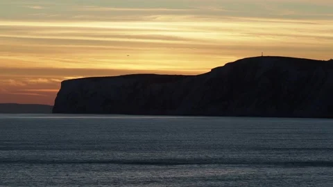 The Beautiful Colours Of The Sky As The Sun Sets Behind The Cliffs Stock Footage 221644802