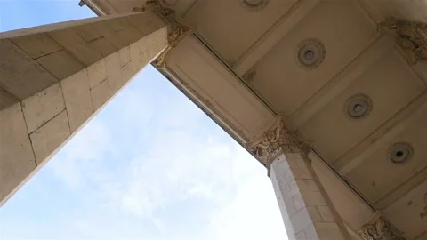 Beautiful columns on a background of blue sky. Slow motion. Camera in motion Stock Footage 103420912