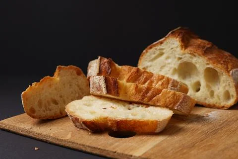 A Beautiful Composition of Artisan Bread Slices Presented on a Dark Background Stock Photos