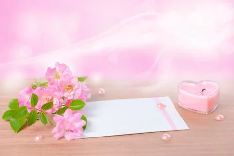 Beautiful composition of delicate pink rose, heart shaped candle, card with p 写真素材