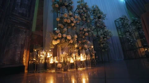 A beautiful composition of many burning candles and fresh flowers Stock Footage 179686220