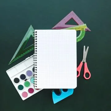 Beautiful composition with notebook scissors ruler watercolors green wood b.. Stock Photos