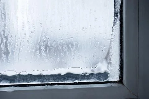 A beautiful condensation pattern forms on a window pane, with delicately falling Stock Photos