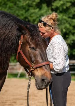 Beautiful connection between human and animal. Woman showing affection to her Stock Photos