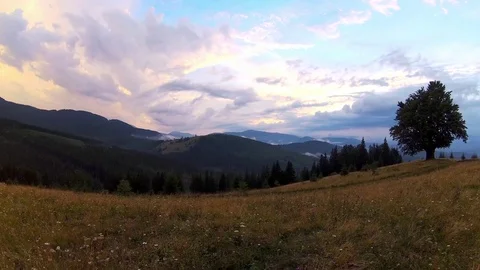Beautiful countryside scenery with dramatic cloudy sky and mountains range Stock Footage 87300771