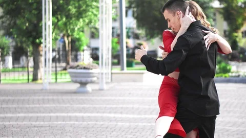 Beautiful couple dancing a salsa in the park Stock Footage 116803577