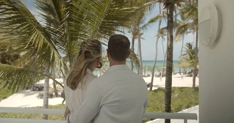 Beautiful Couple Embracing on Resort Balcony, Beach & Ocean View Stock Footage