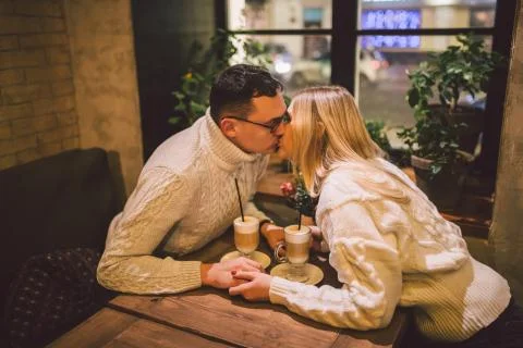 Beautiful couple having coffee on a date,having fun together. Couple young Stock Photos